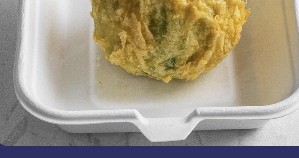 Pea fritter in a takeaway tray